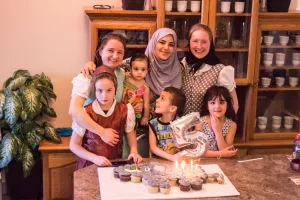 a family of Hutterites with a family of refugees