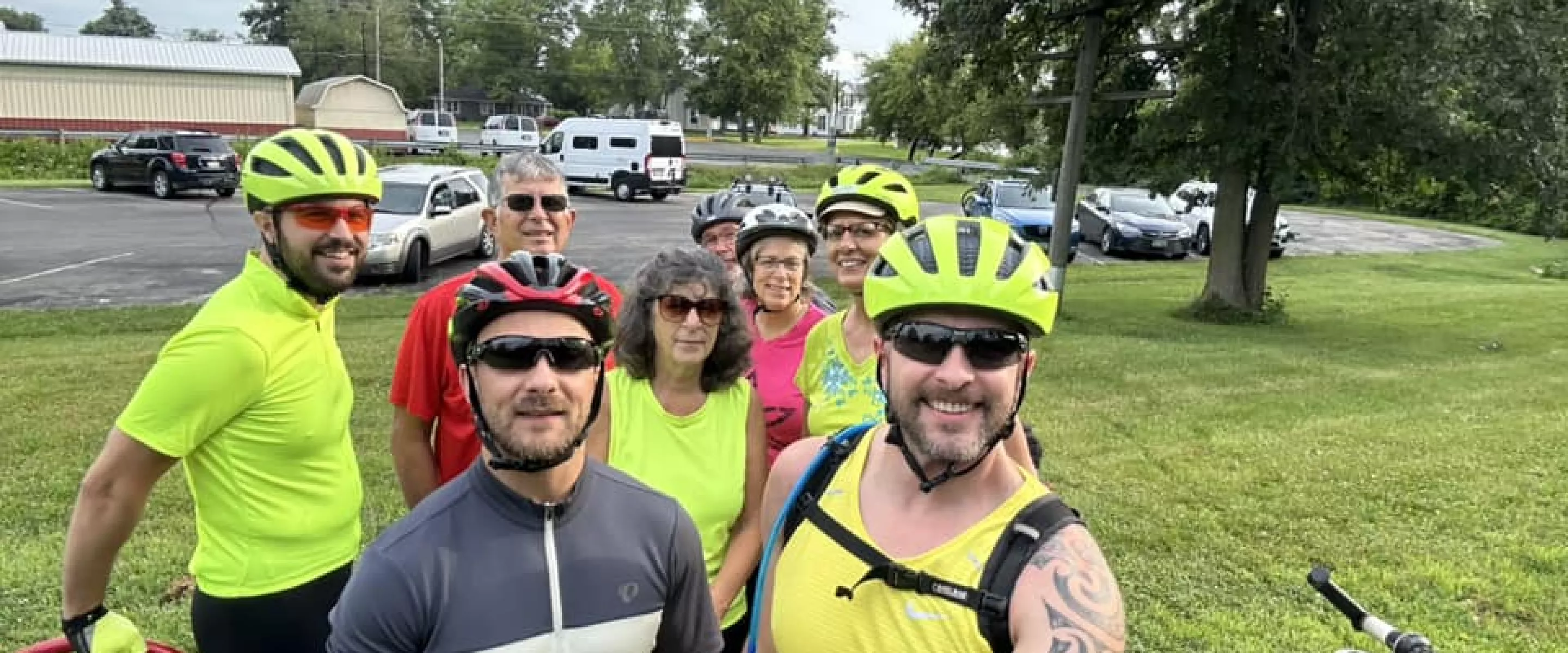 group of bicycle riders smile at camera
