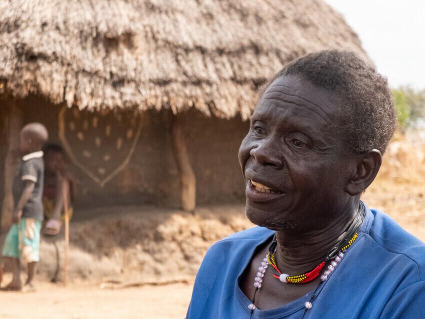 A Ugandan village elder in a blue shirt