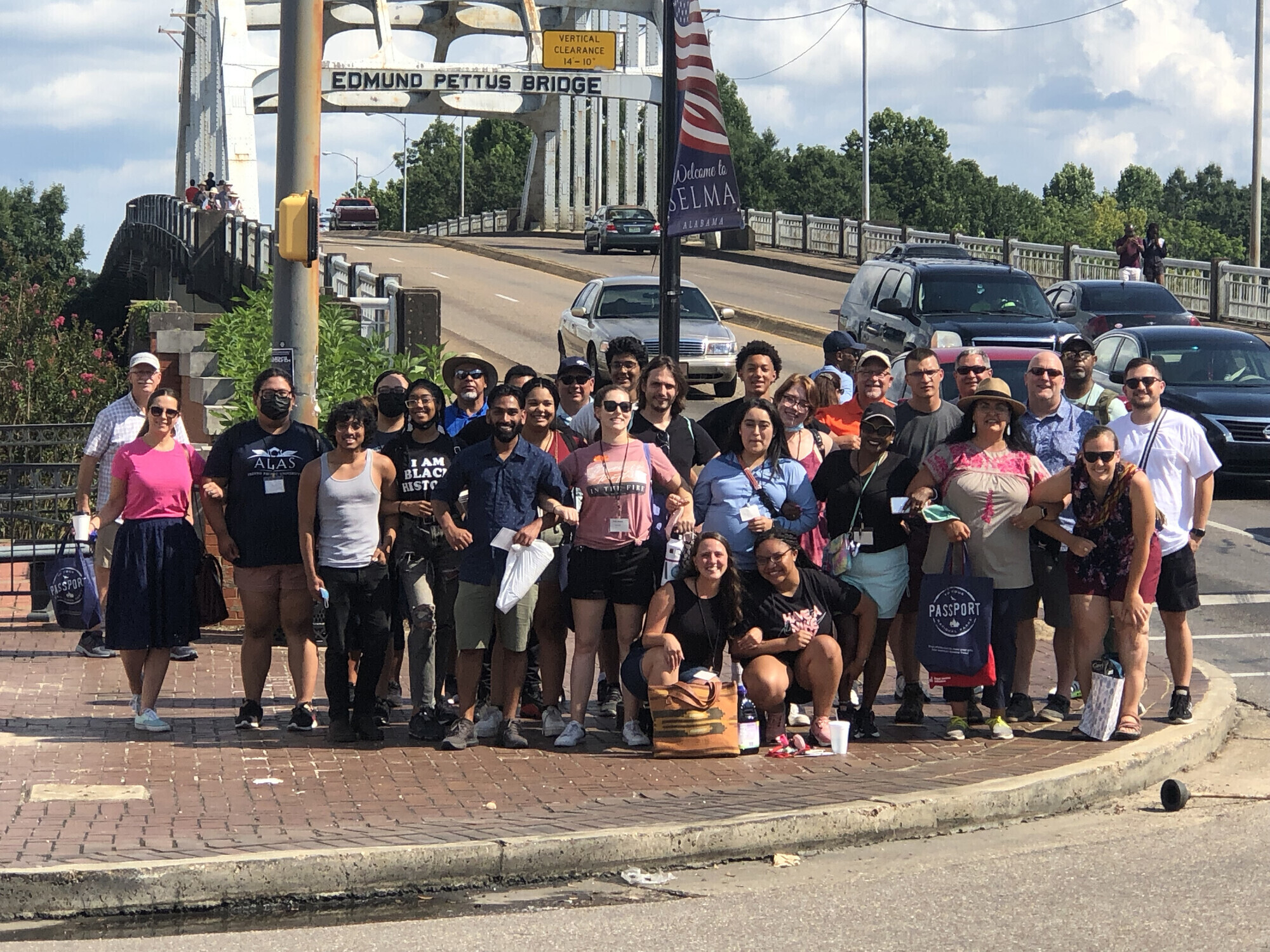 Group standing in front of Edmund Pettis Bridge in Selma, Alabama.