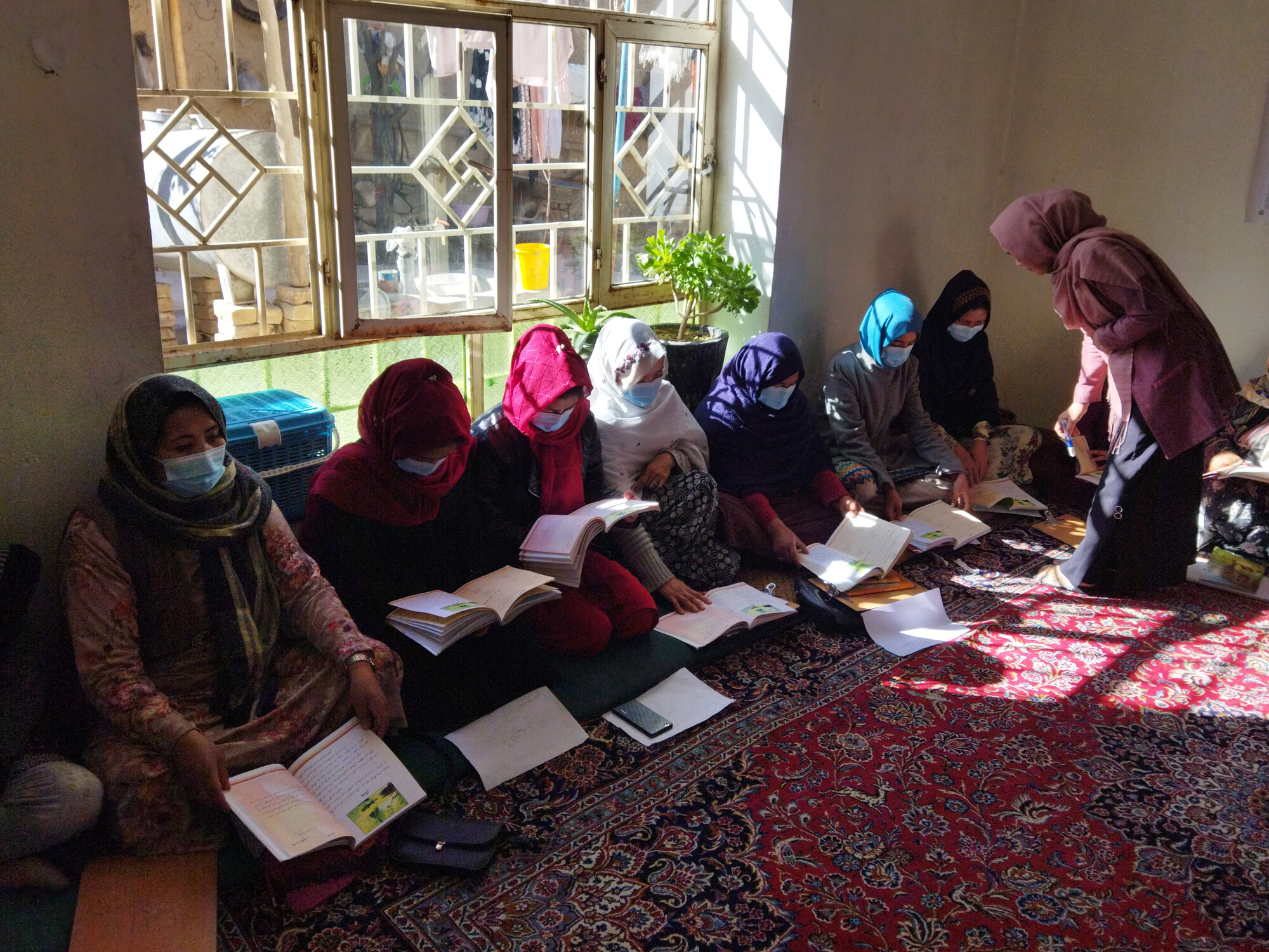 Women and teenage girls* participate in a literacy learning circle in Kabul, Afghanistan.