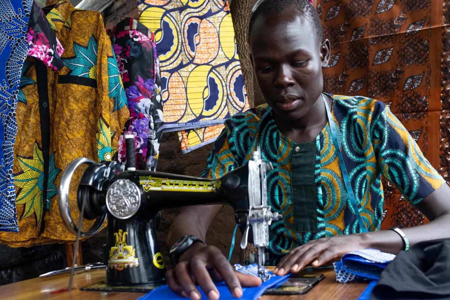 Augustine Bidali uses his training in tailoring to support his three younger brothers.