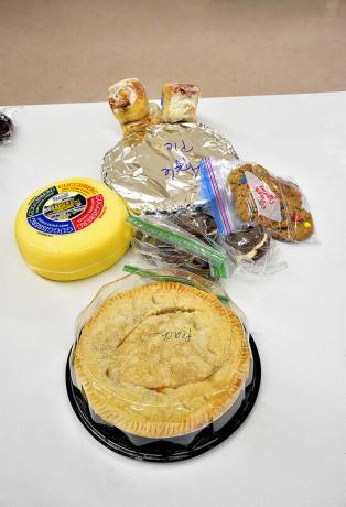 A small collection of baked goods and cheese sitting on a table