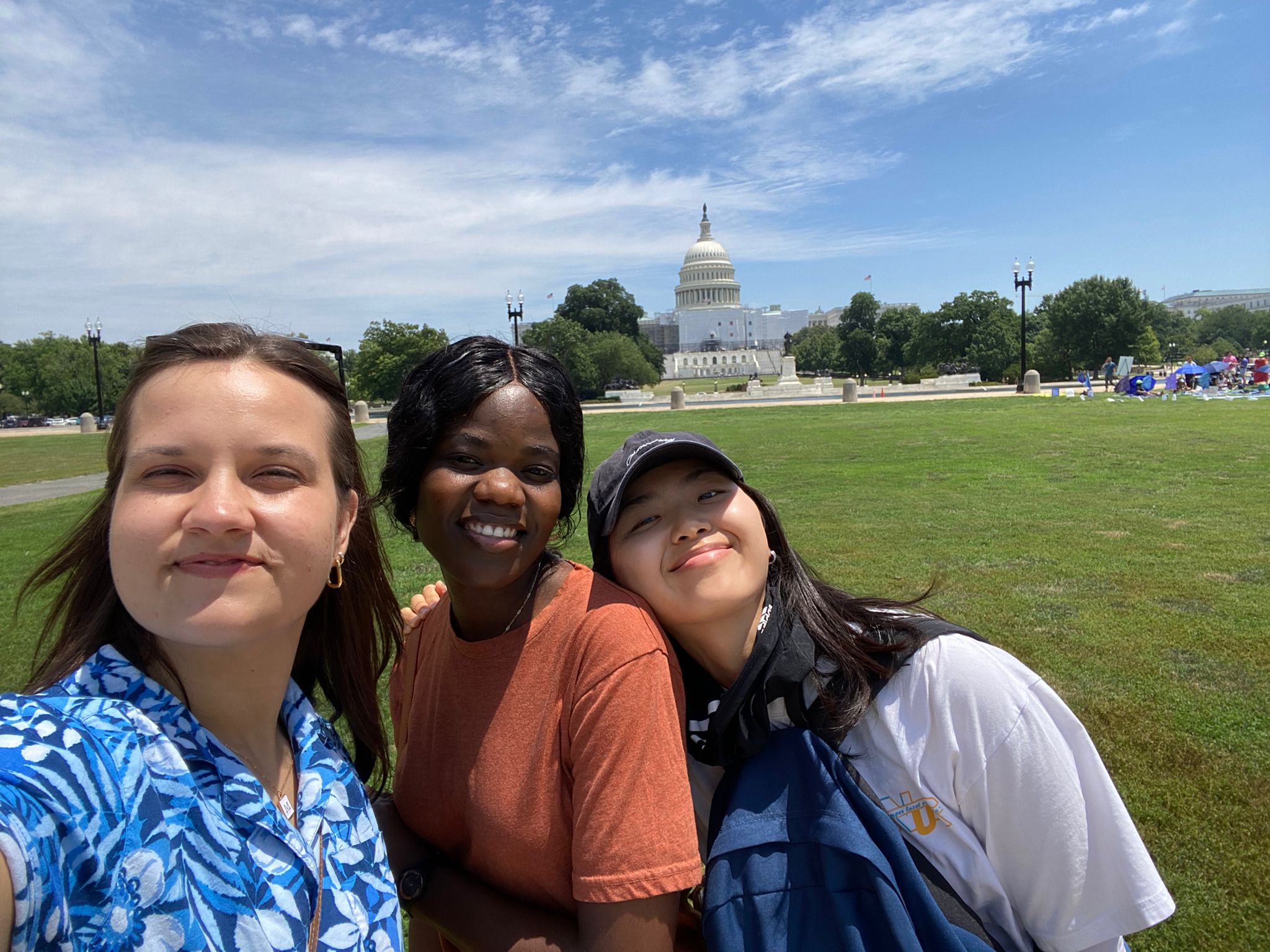 Three young women taking a selfie photo in front of the US Senate building