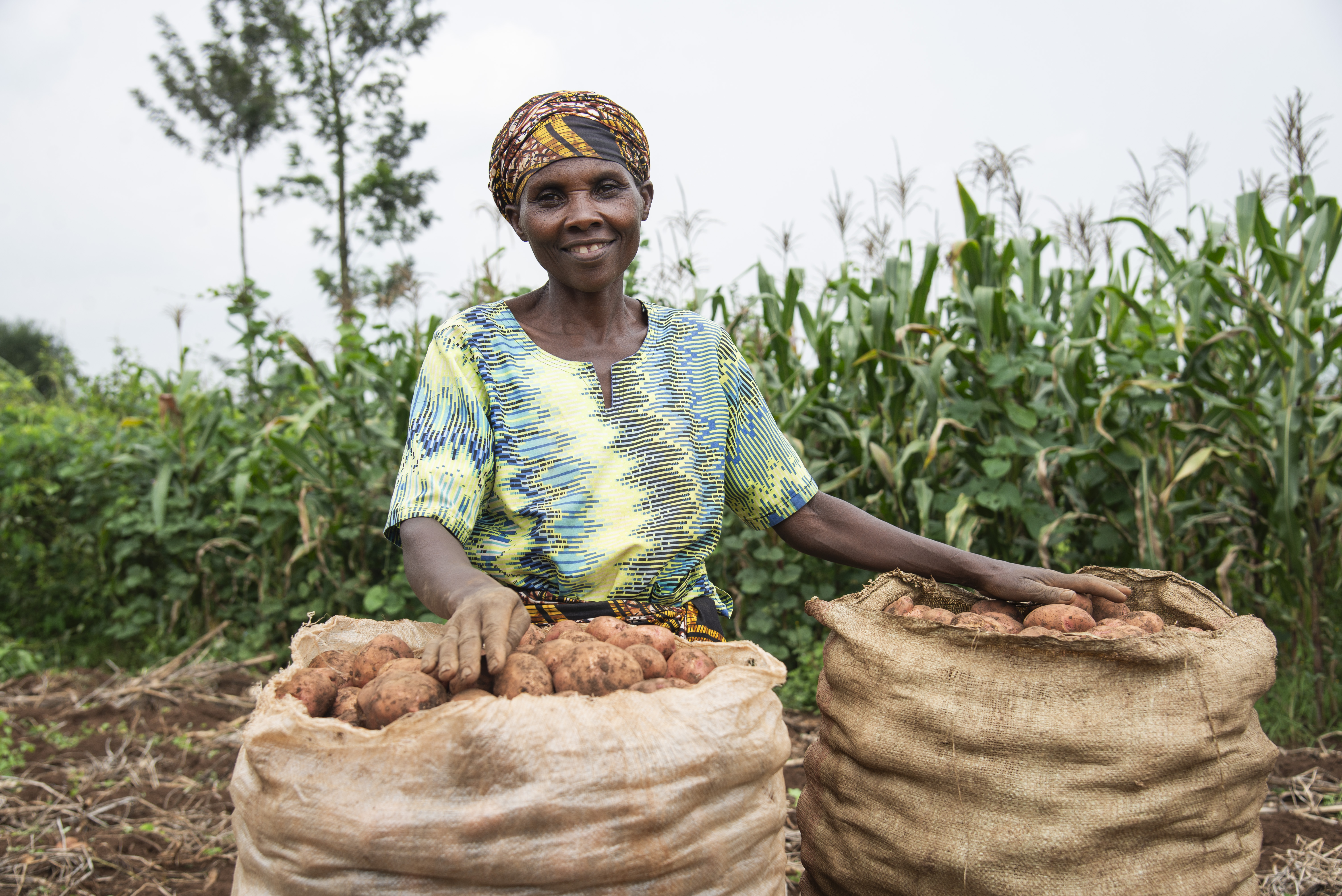 a woman smiles with her crops