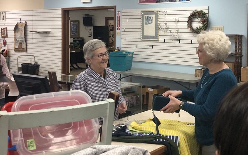 Volunteer Judy Beachy checks out customer Joy Detweiler at the cash register in the Depot MCC Thrift Shops in Goshen, Indiana.