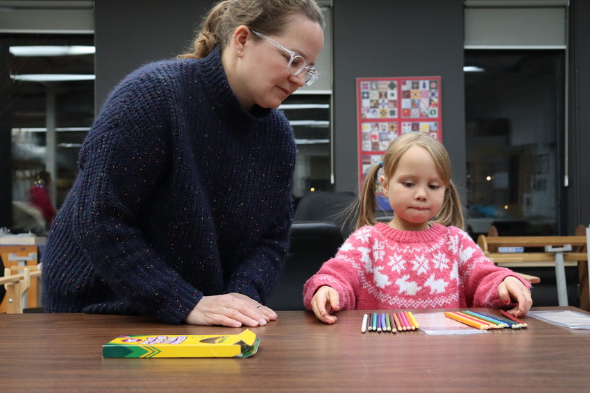 Susanne du Plooy and her daughter Marie du Plooy dividing a large pack of pencil crayons into two smaller ones to add to an MCC school kit.

The Fort Garry Emmanuel Mennonite Church Kid’s Club came