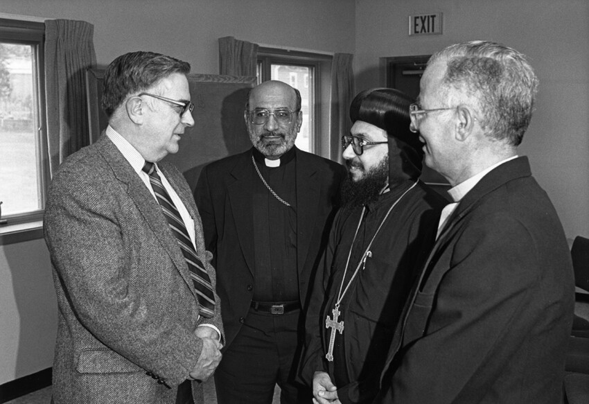 MCC executive secretary John A. Lapp, left, talks with, left to right, Archbishop Gewargis Sliwa of Iraq’s Apostolic Assyrian Church of the East; Coptic Orthodox Bishop Thomas of Assiut, Egypt; and