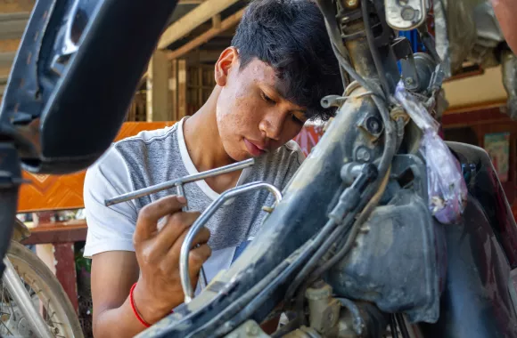 A man working on a motorcycle