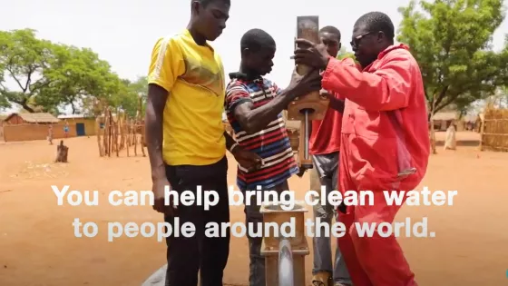 Four men install a well in Chad. Text on the screen says, "You can help bring clean water to people around the world."
