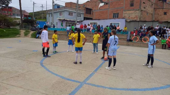 Children playing soccer/football in a school yard in Colombia