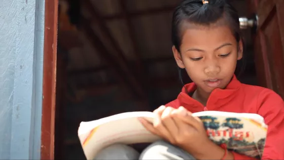 A Cambodian girl studies a book