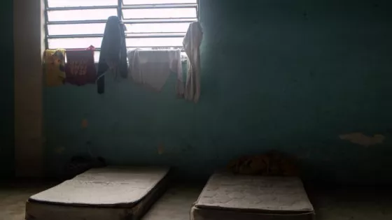 Two mattresses on the floor at a migrant shelter