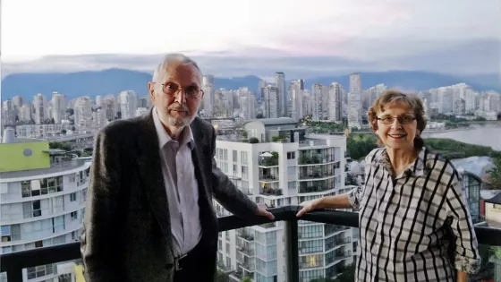 A man and woman standing in front of a city skyline 