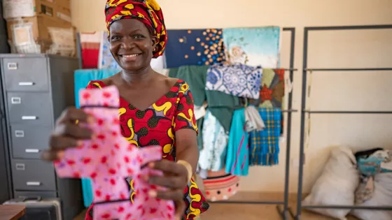 Millicent Teresa Otieno, 42, Loreto Rumbek School sewing instructor, holds an example of the reusable menstrual pad finished by the school dignity kit sewing project.