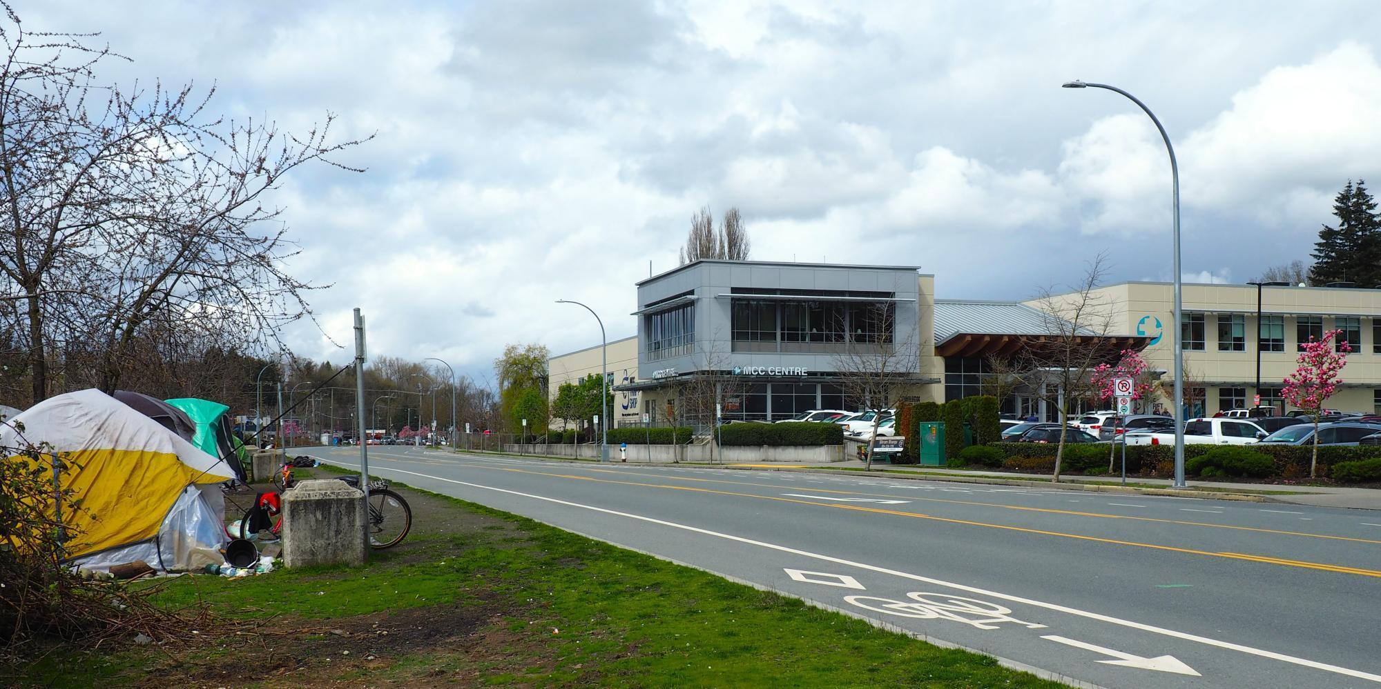 The exterior of MCC BC's office in Abbotsford near a road with many tents pitched to the side