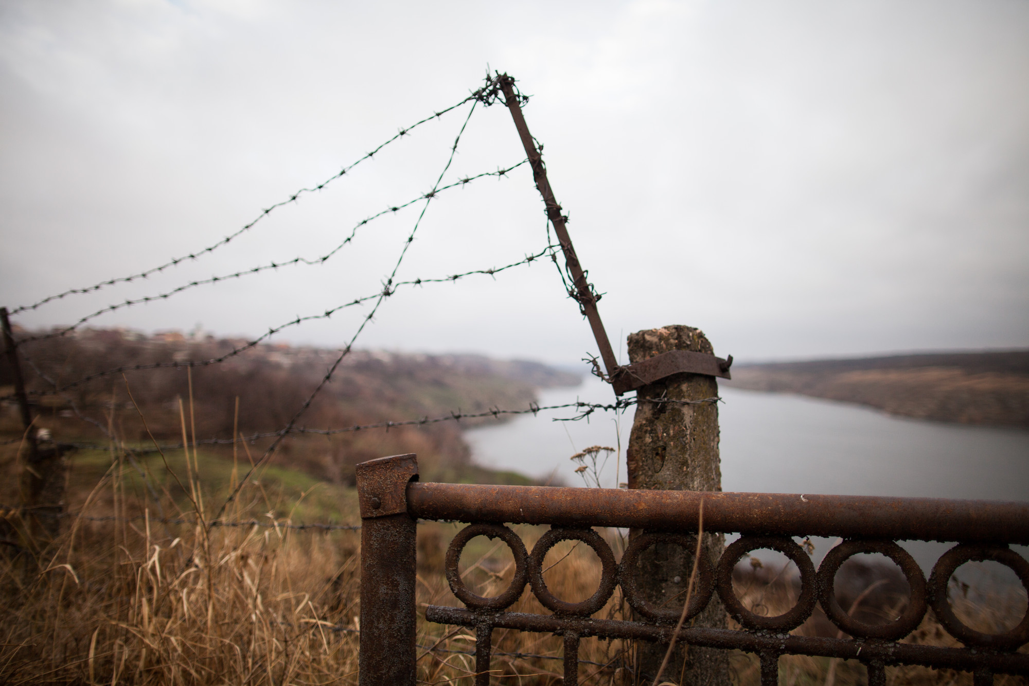 A barbed wire fence near a river