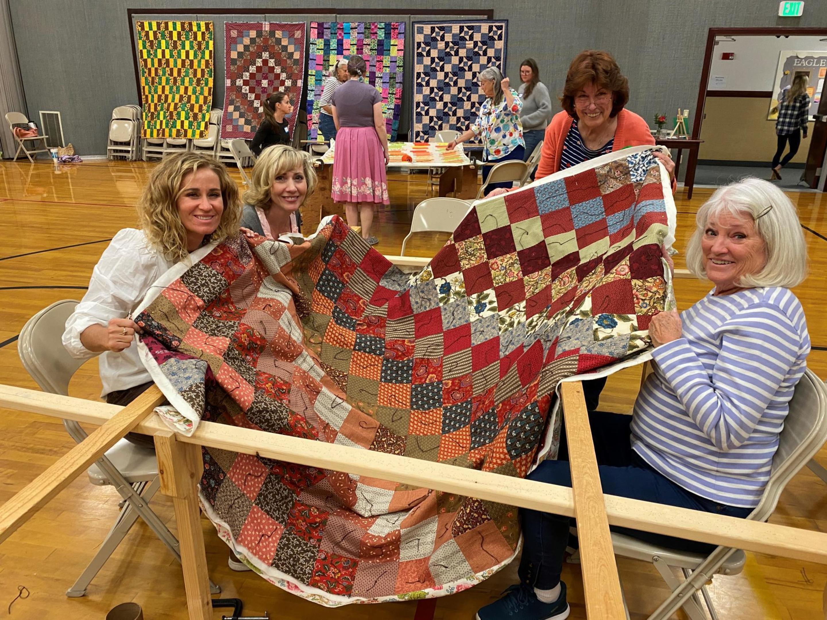 A group of women working on a comforter