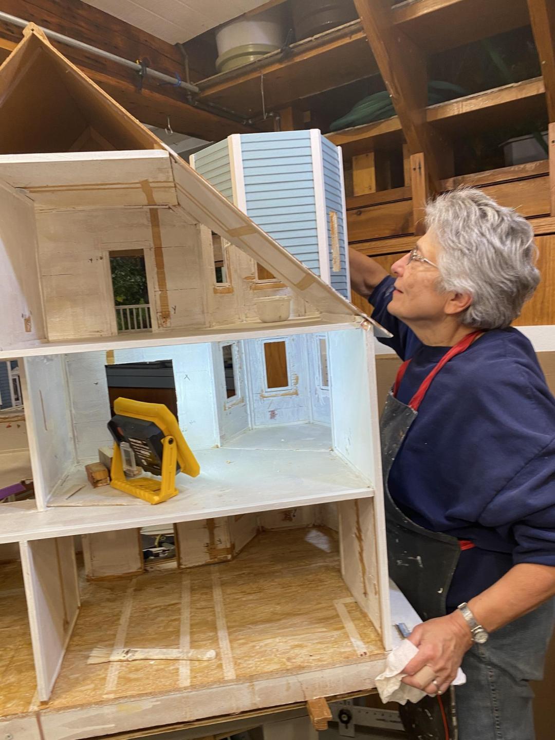 Sharon Ewert works on one of the many dollhouses that she and her husband Norm have donated to MCC over the years. The project began as an extension of the Thursday night "Menno Meals" they hosted in their home.