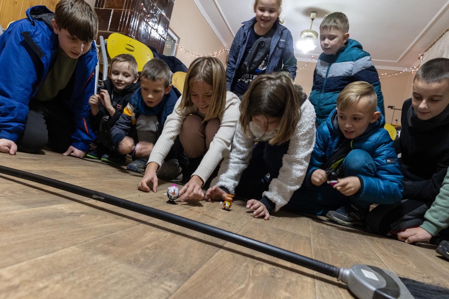 Children playing with marbles in a shelter