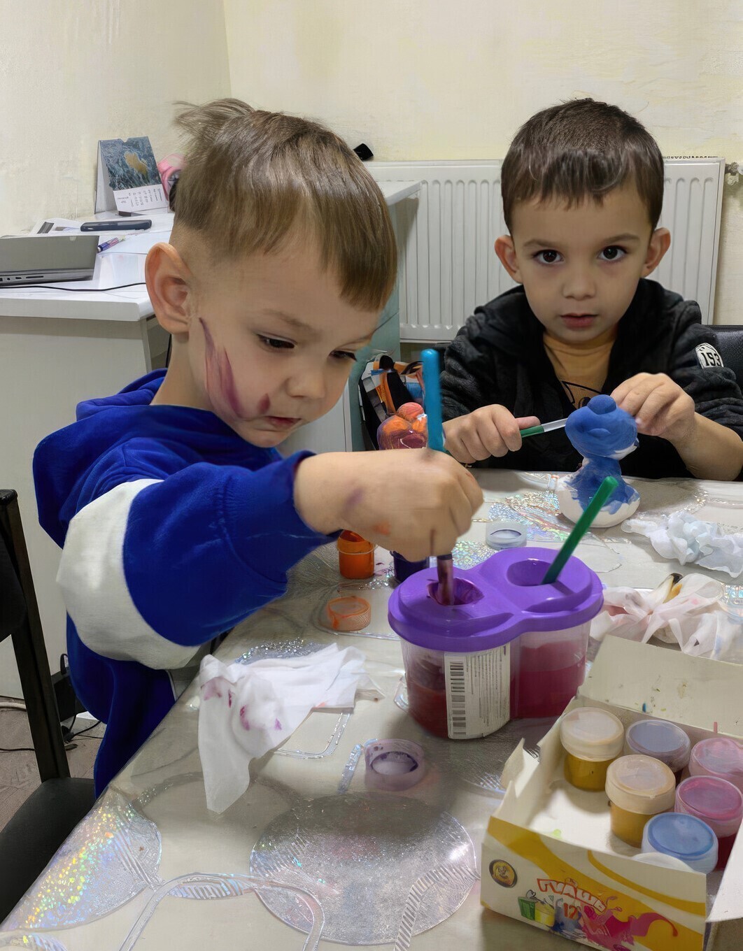 Two children playing with clay