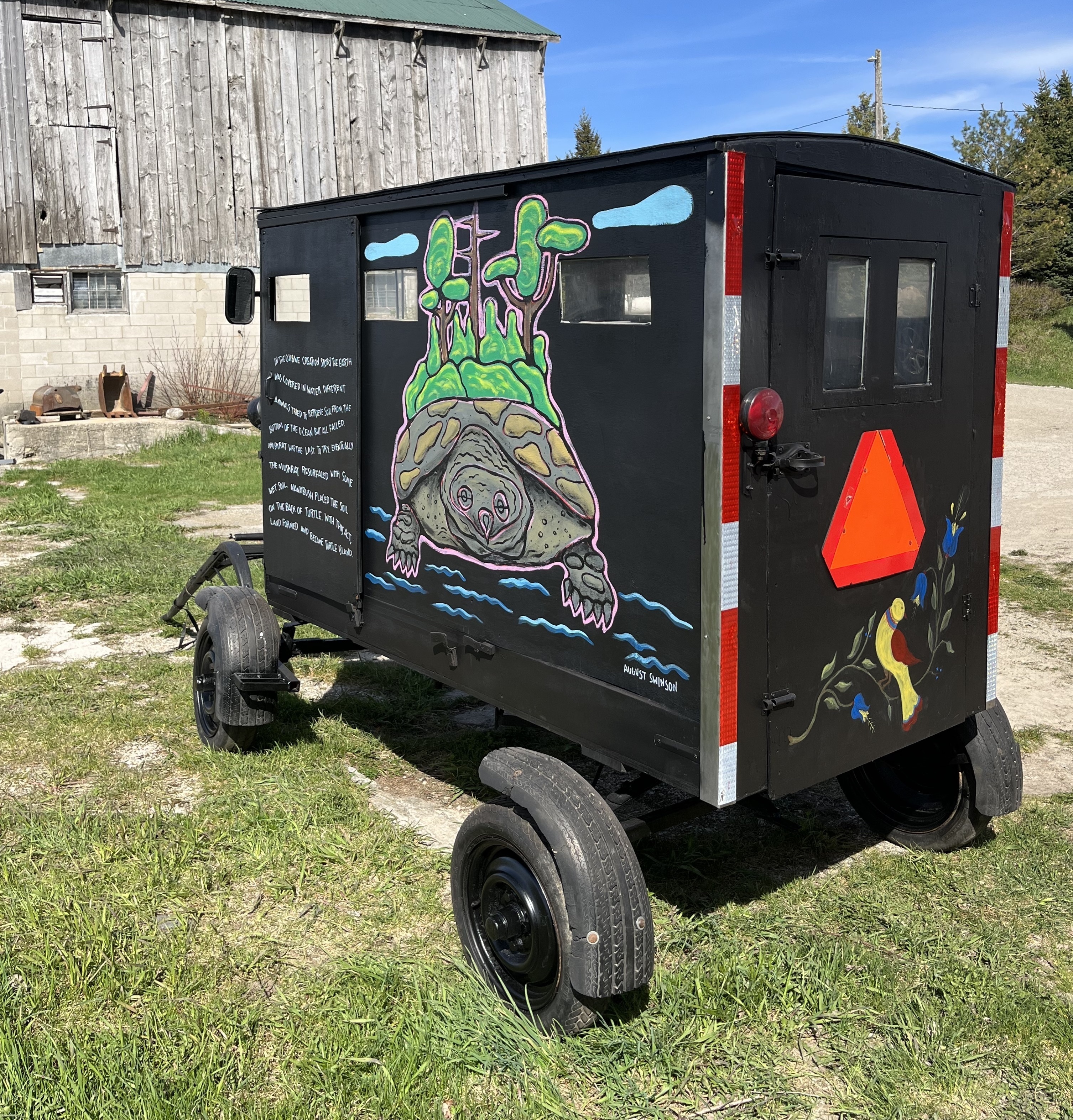 An Amish buggy that has been painted with a mural