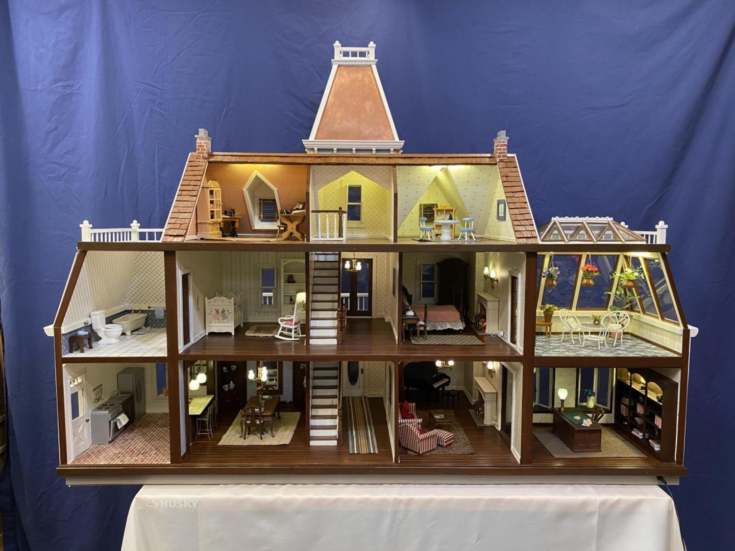 The Ewerts take great care in making custom furnishings for each dollhouses, even equipping them with electricity.