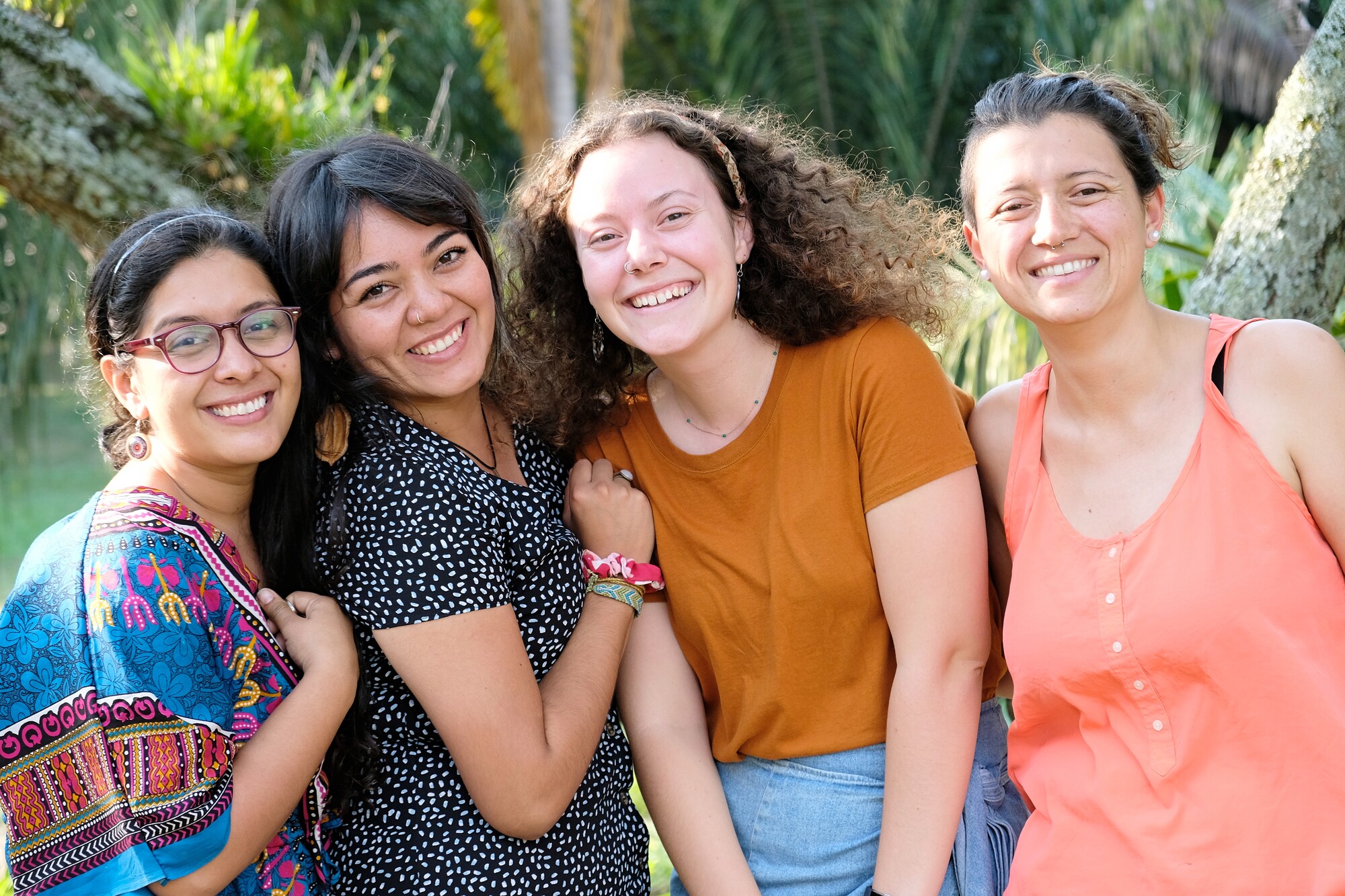 A group of four young women smiling for the camera