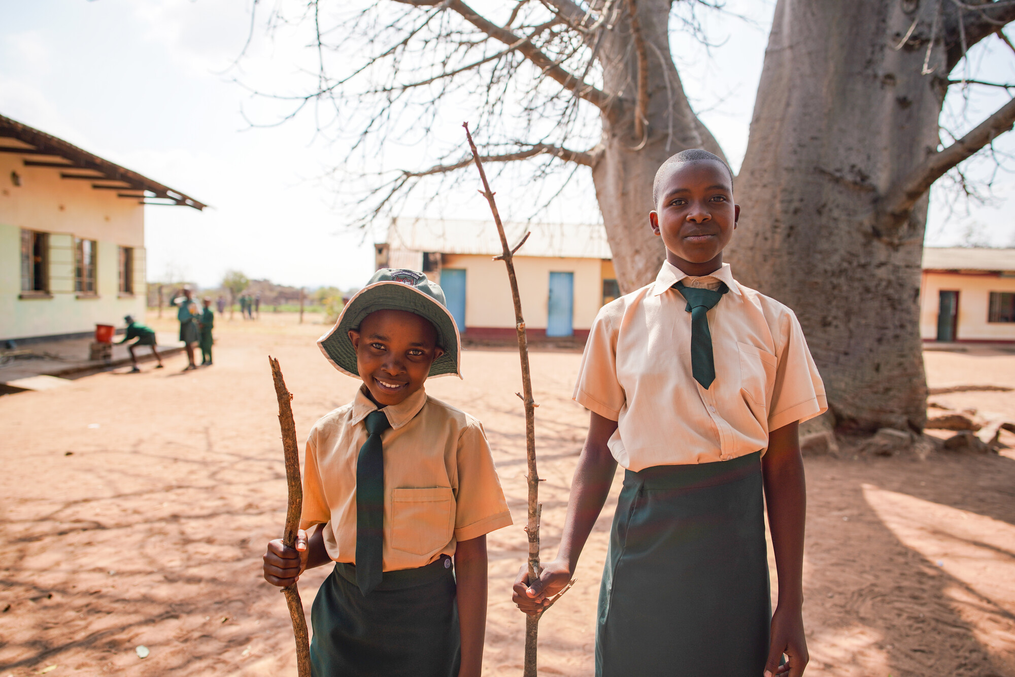 Two children stand in a school yard