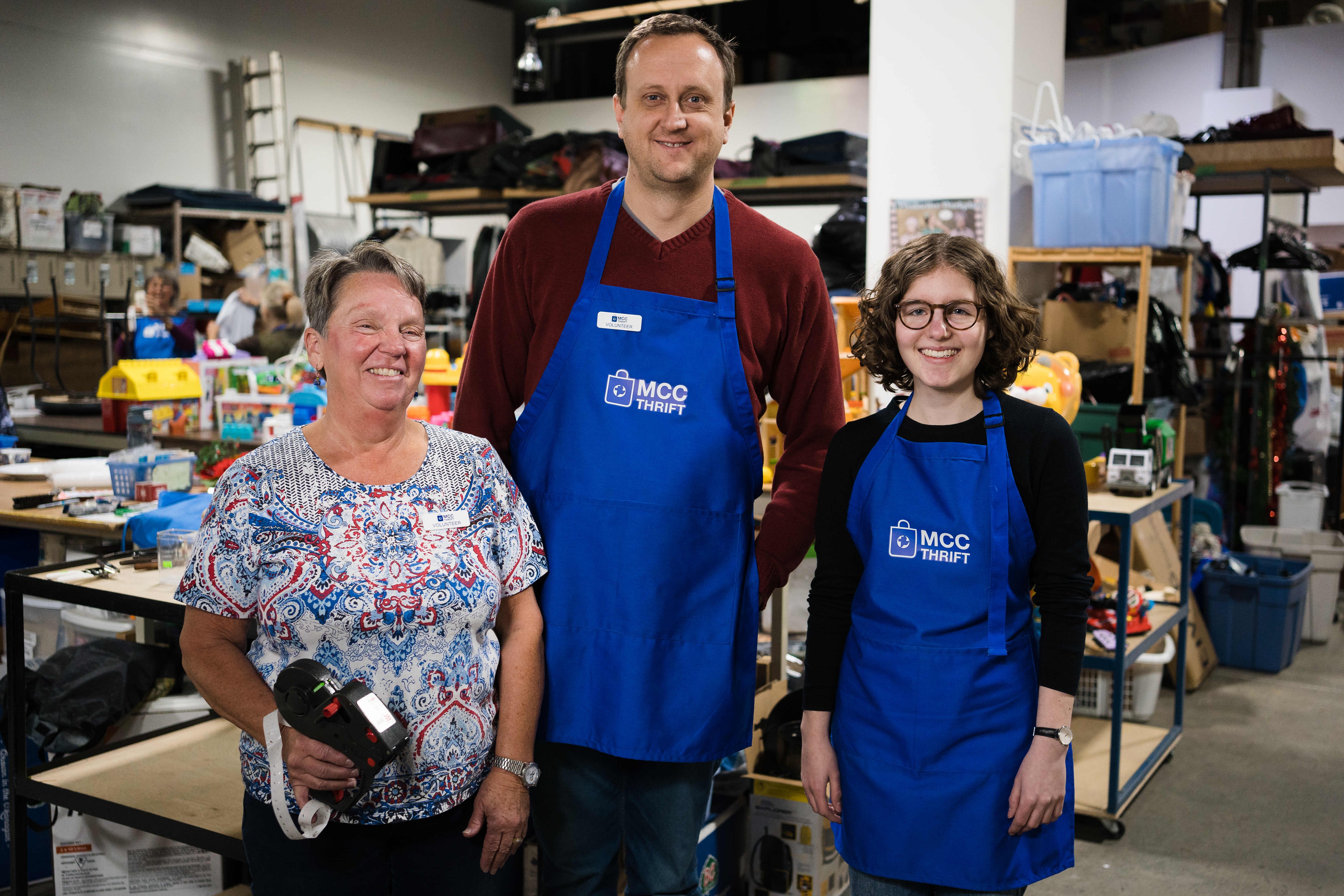 Volunteers Janice Wiggins (left), Alexander Germann (middle) and Lucia Dück (right) in the donation department of the Edmonton MCC Thrift Shop.