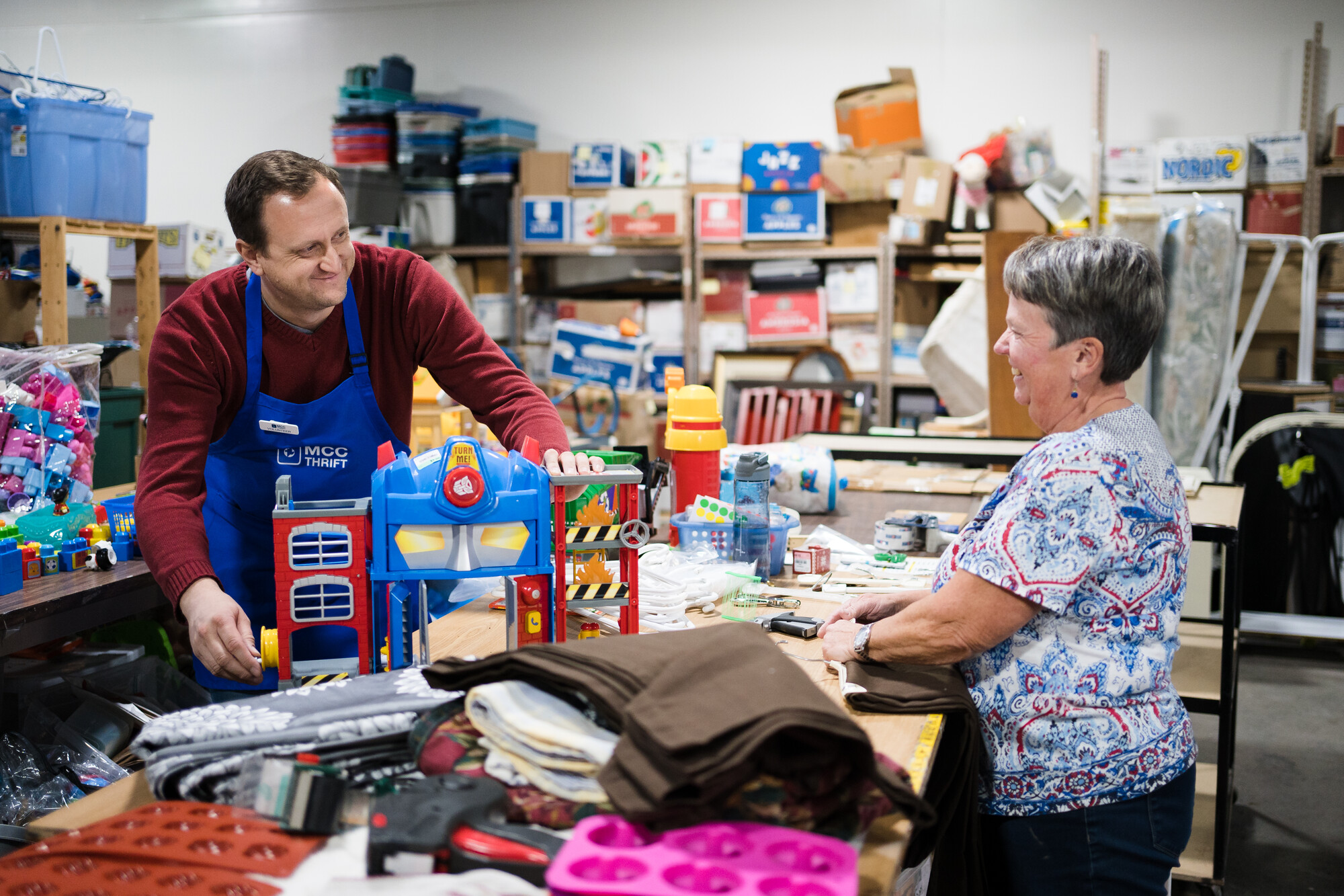 Thrift store volunteers sorting donated items