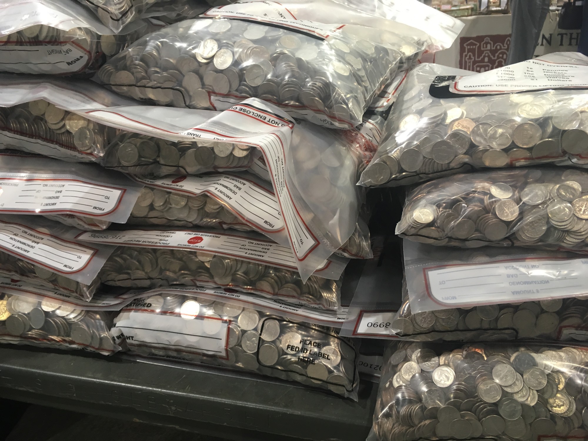 Piles of plastic bags filled with coins