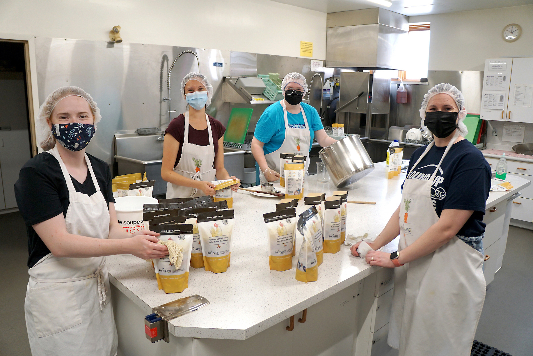 Four women working in a kitchen