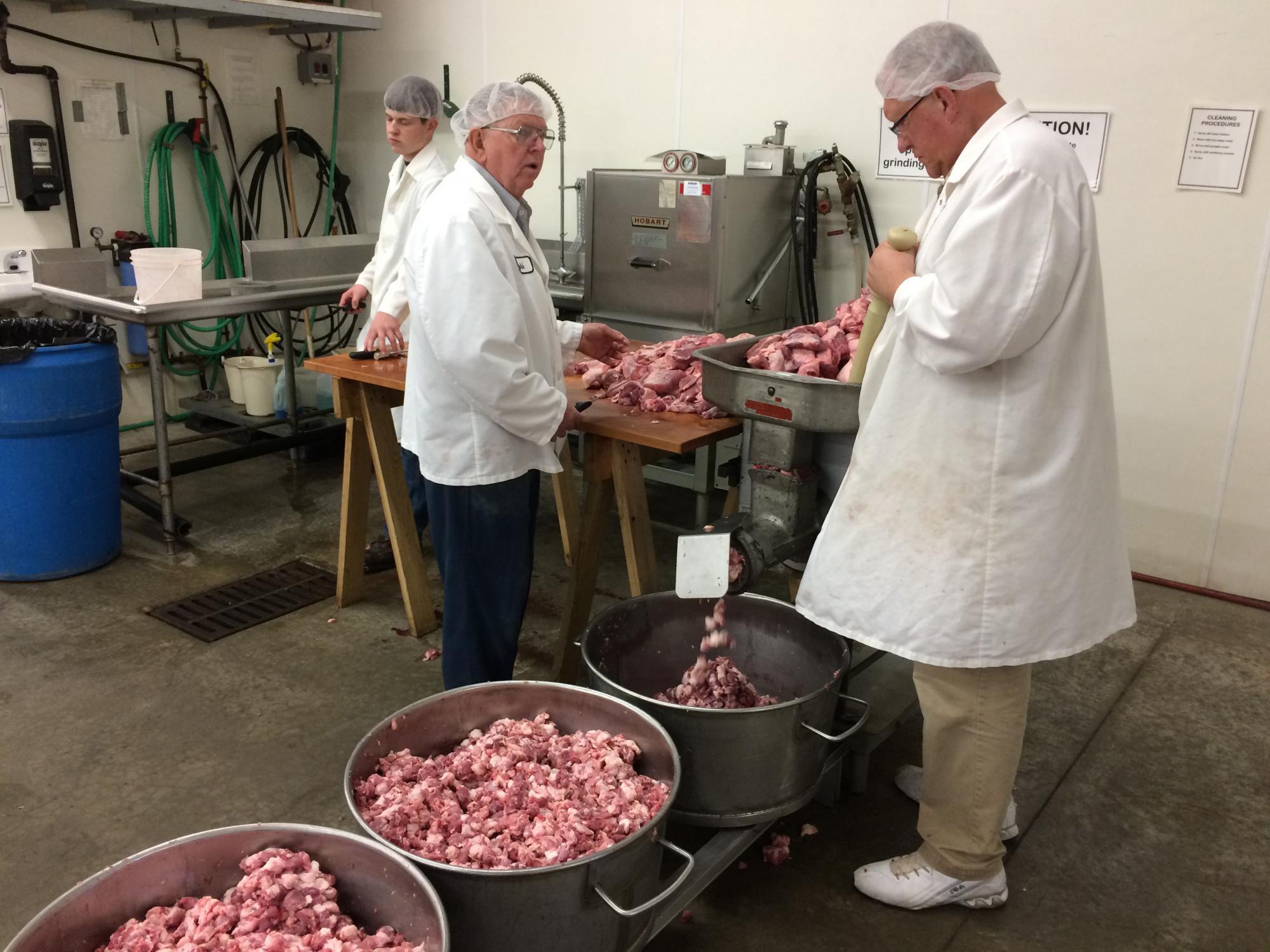 Meat being cut and processed