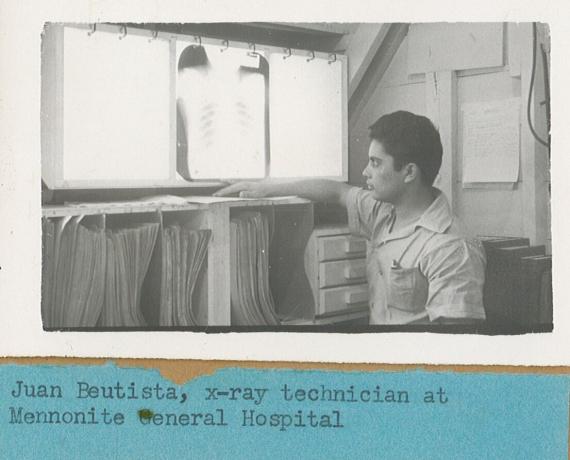 A black and white photo from 1940 of a man standing in front of an x-ray display