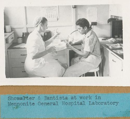 A photo from the 1940s of two people sitting in a hospital clinic