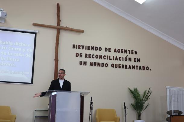 A man standing behind a pulpit in a church