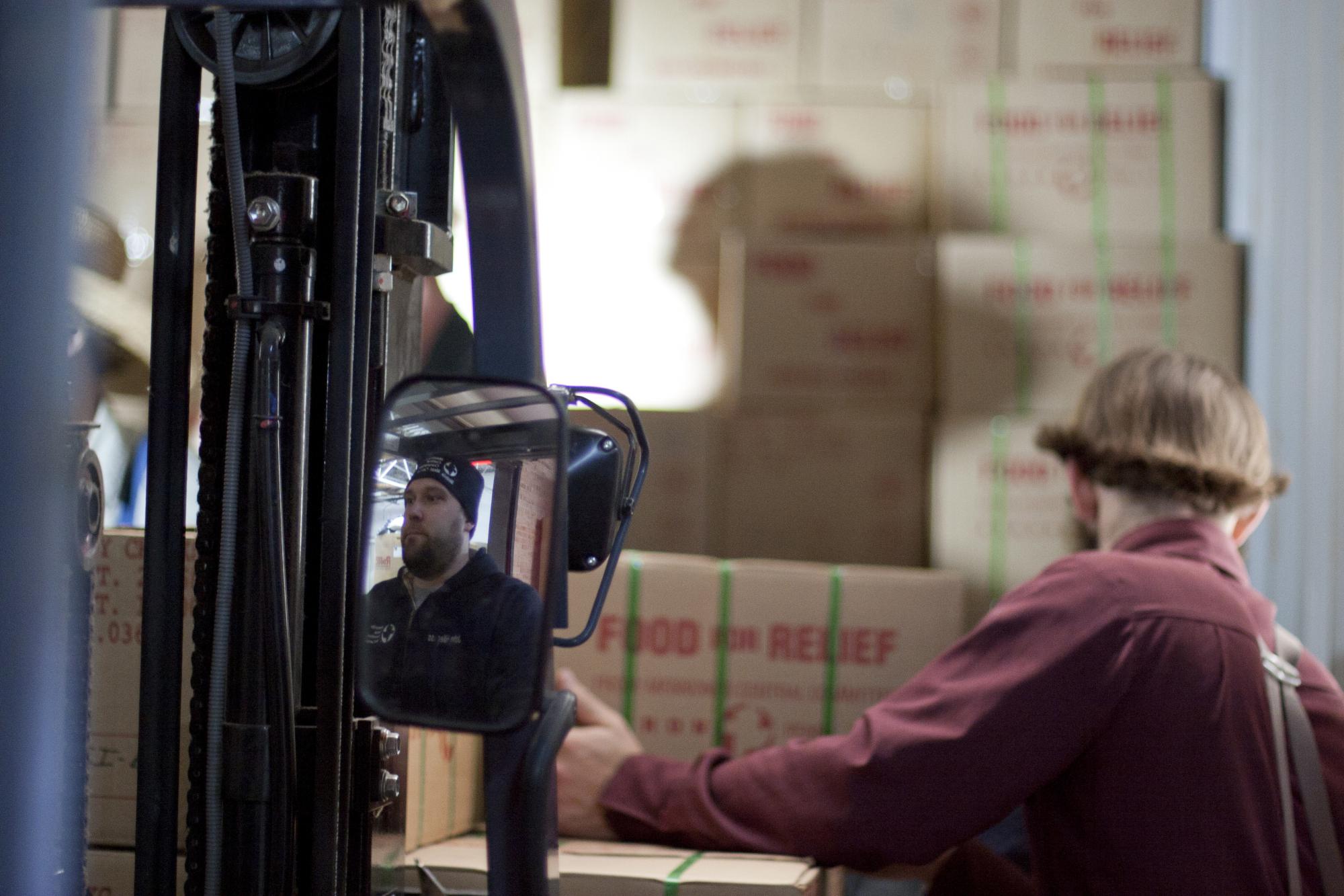 Canned meat is loaded onto trucks headed for the Phillipines