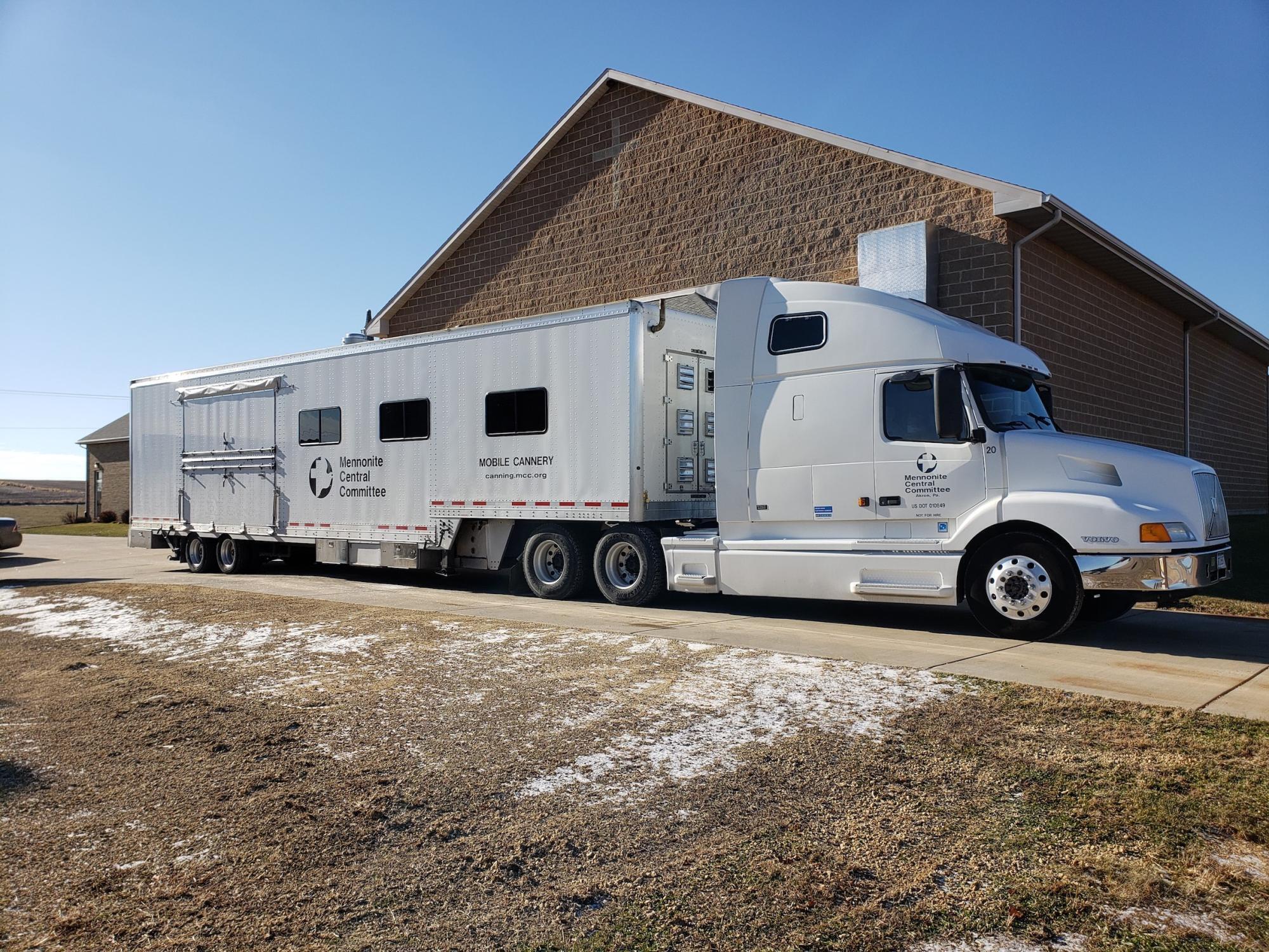 White tractor trailer truck with modified trailer attached