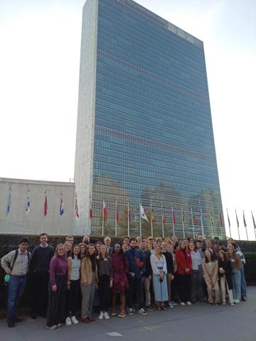 Group of forty-three students who participated in the UN Student Seminar stand in front of the United Nations building in New York City.