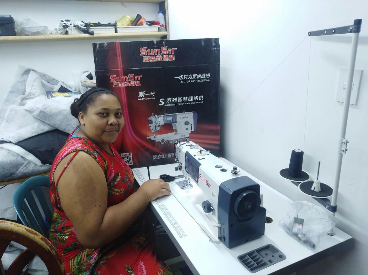 A woman sitting at a sewing machine