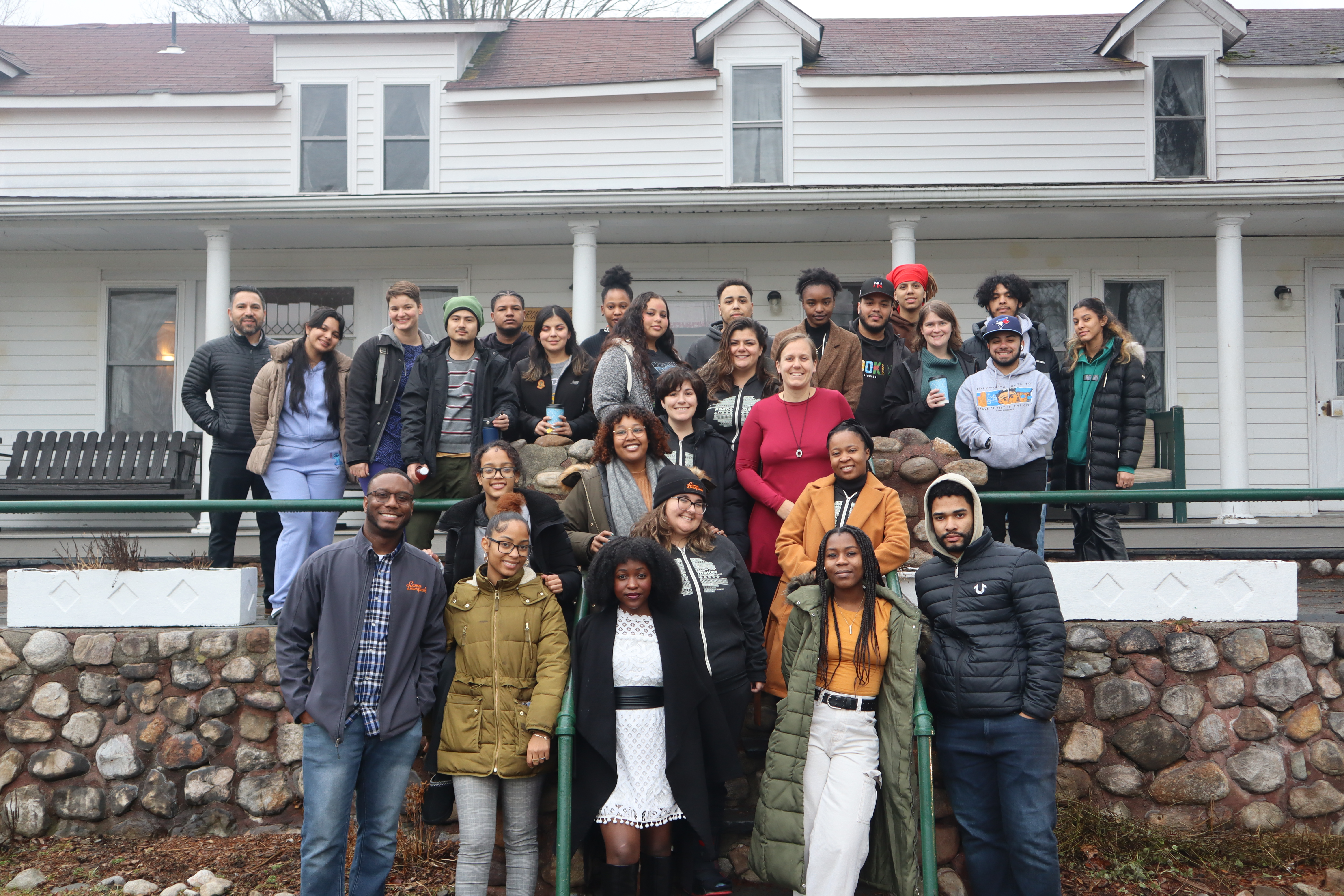 A group of young adults gather for a photo.