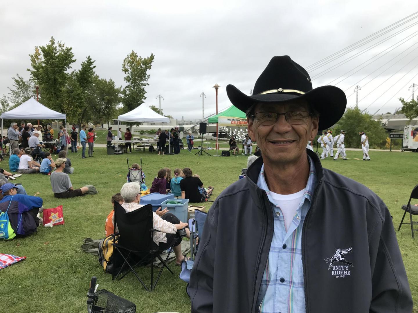An Indigenous man in a cowboy hat at an outdoor event