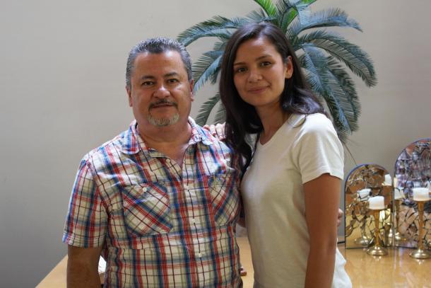 A man and a woman stand together for a photo