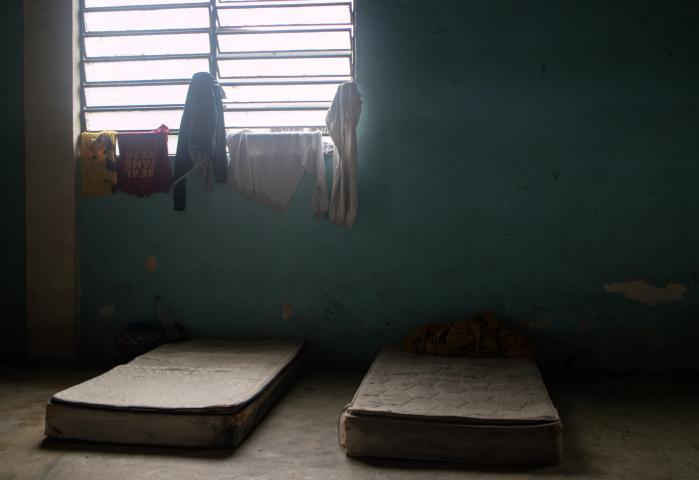 Two mattresses on the floor at a migrant shelter