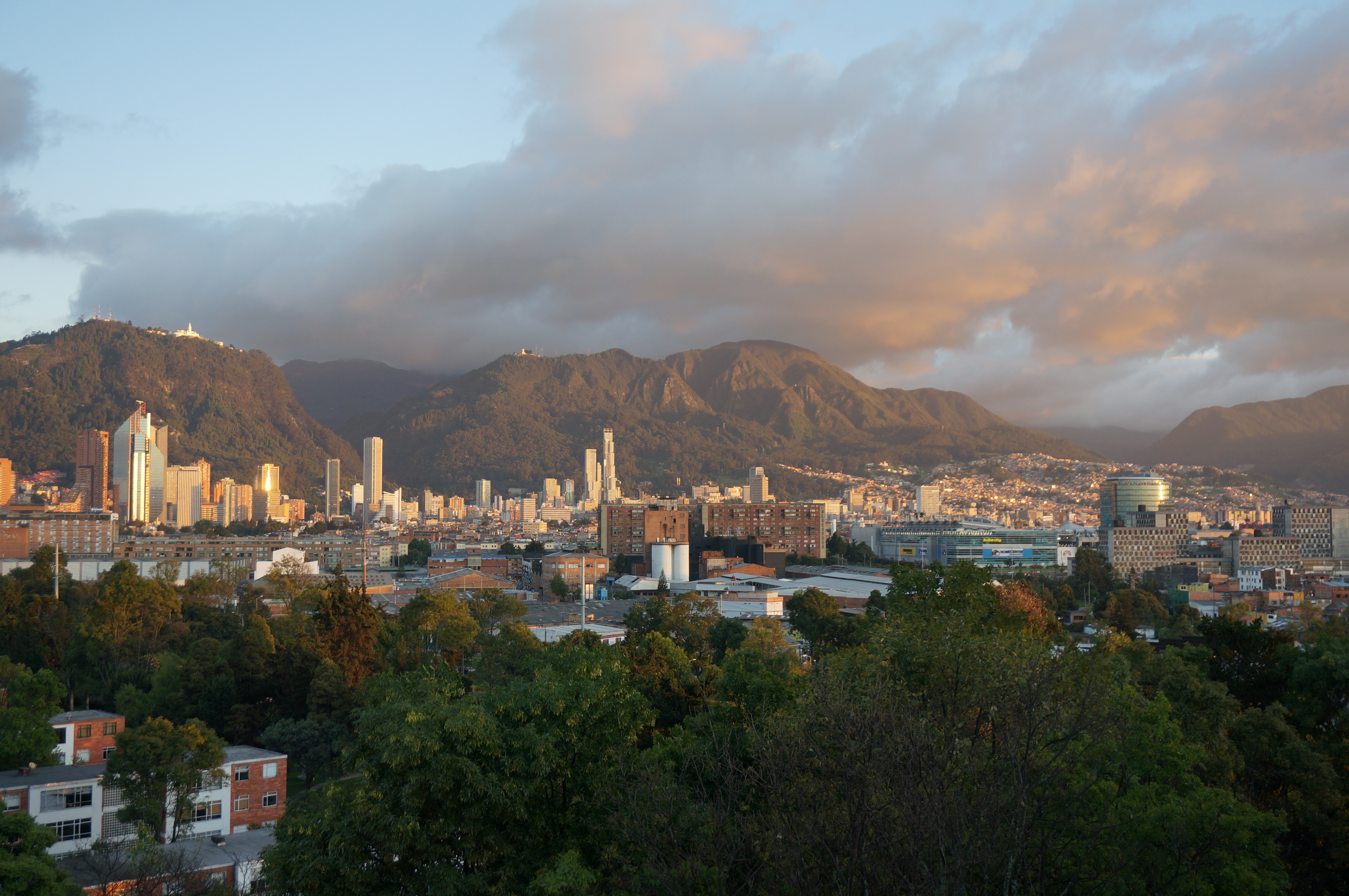 A city landscape with mountains in the distance