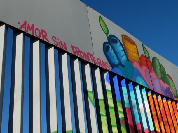 A section of border wall painted with a mural