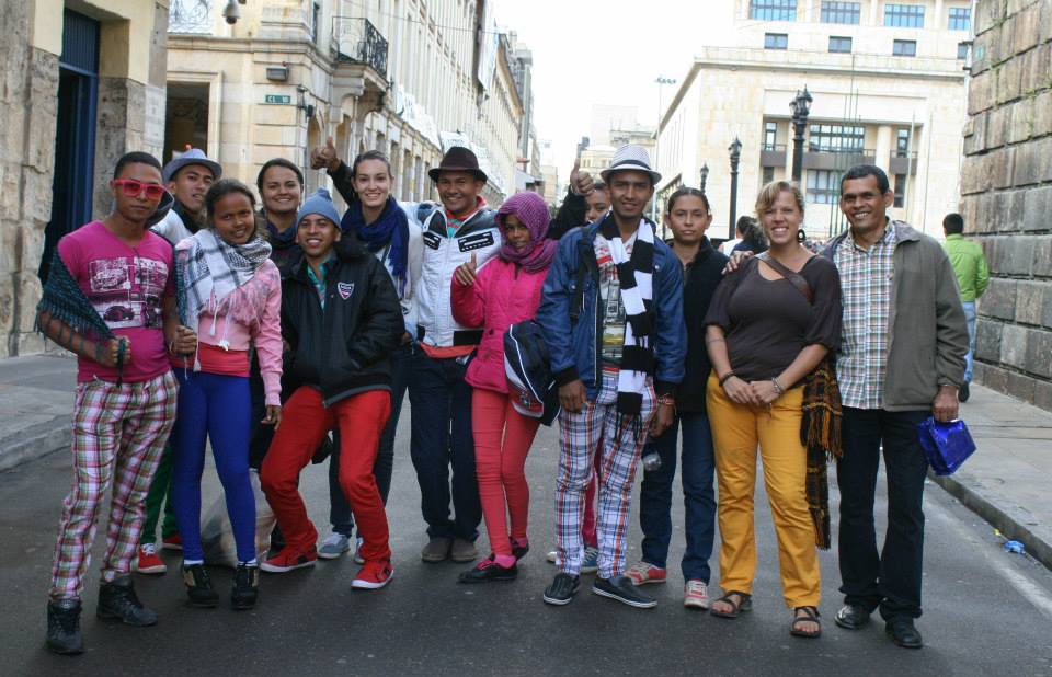 A group stand in a street in Bogota.