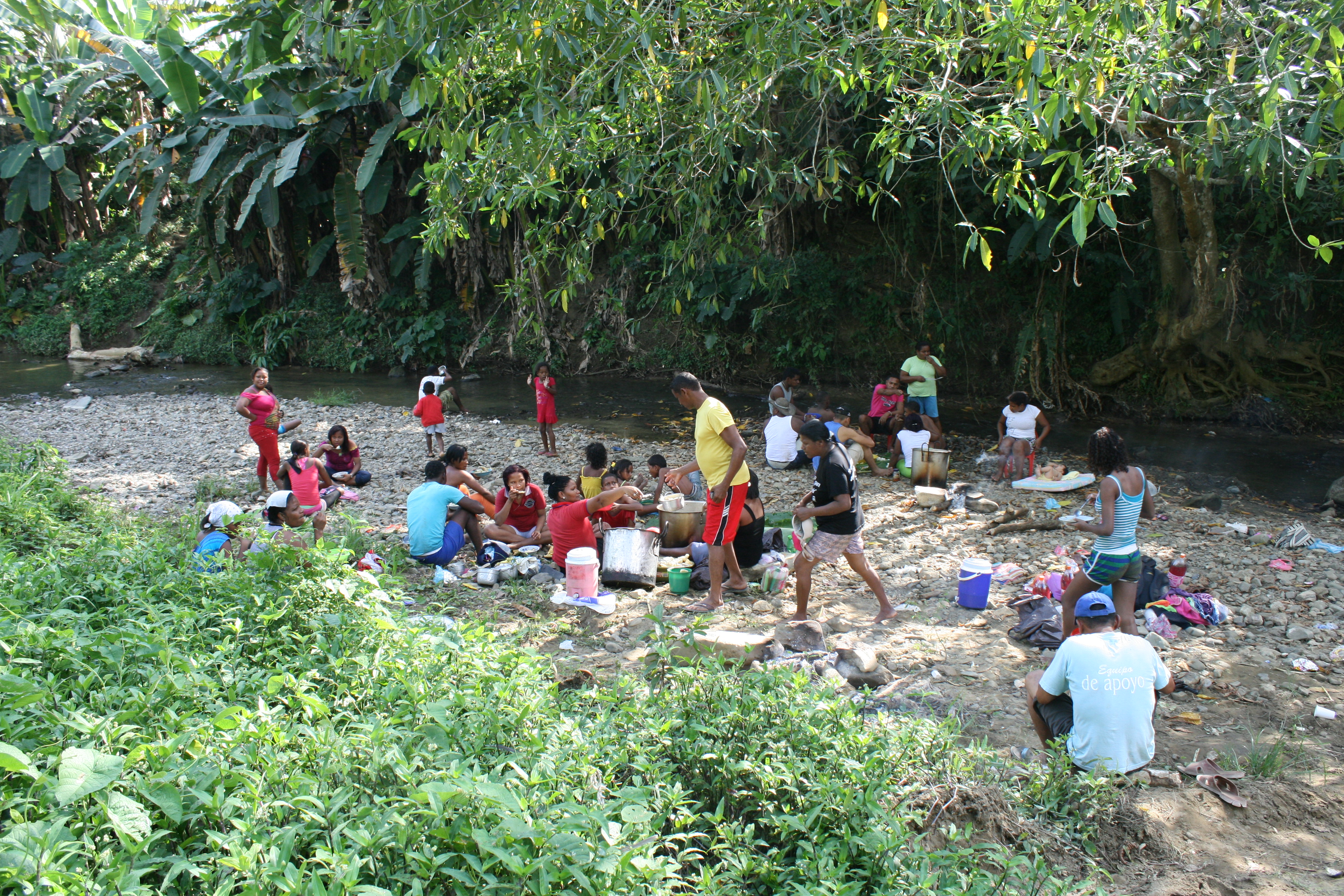 A community picnic on along a creek