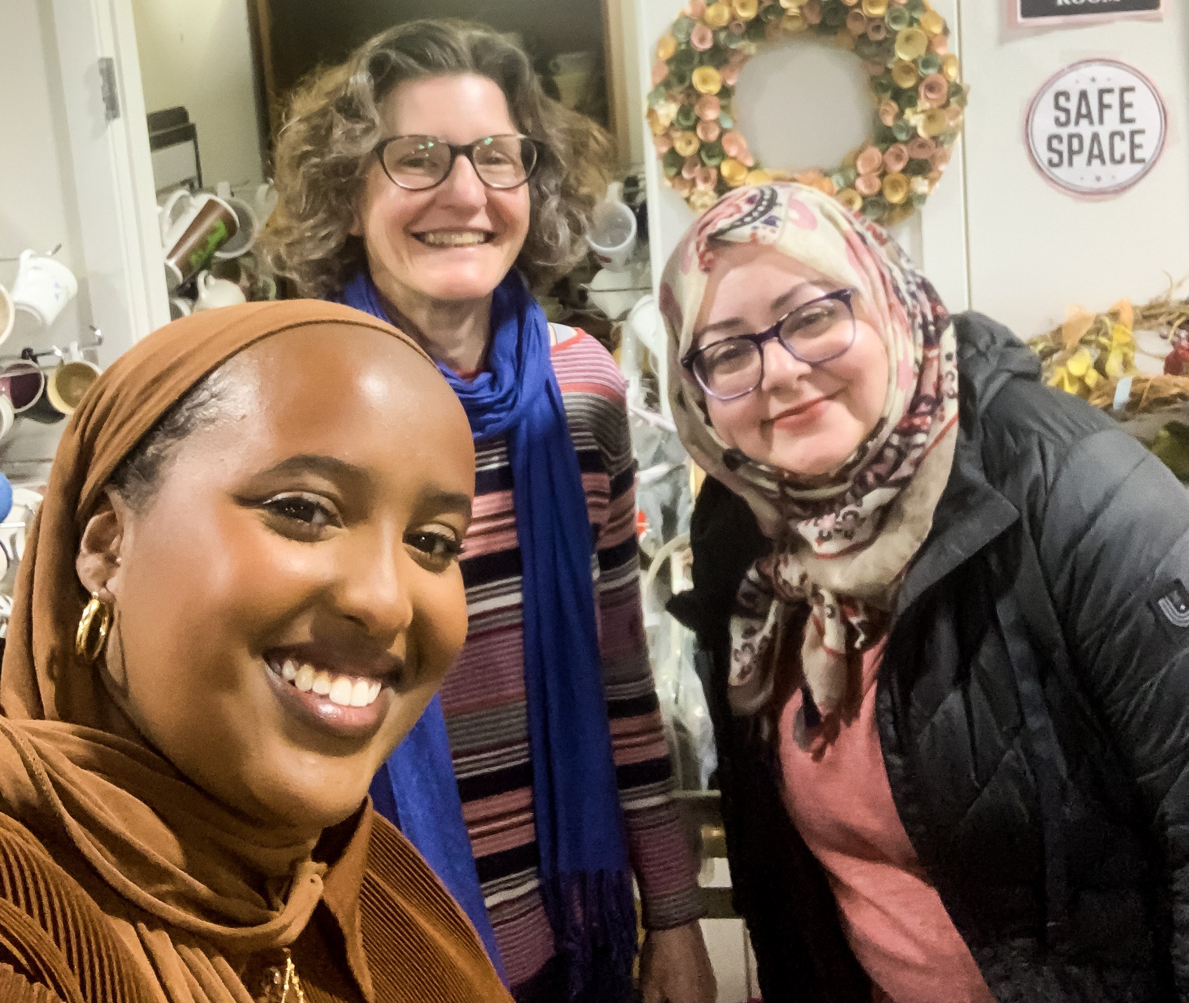 Three women smiling for a selfie photo